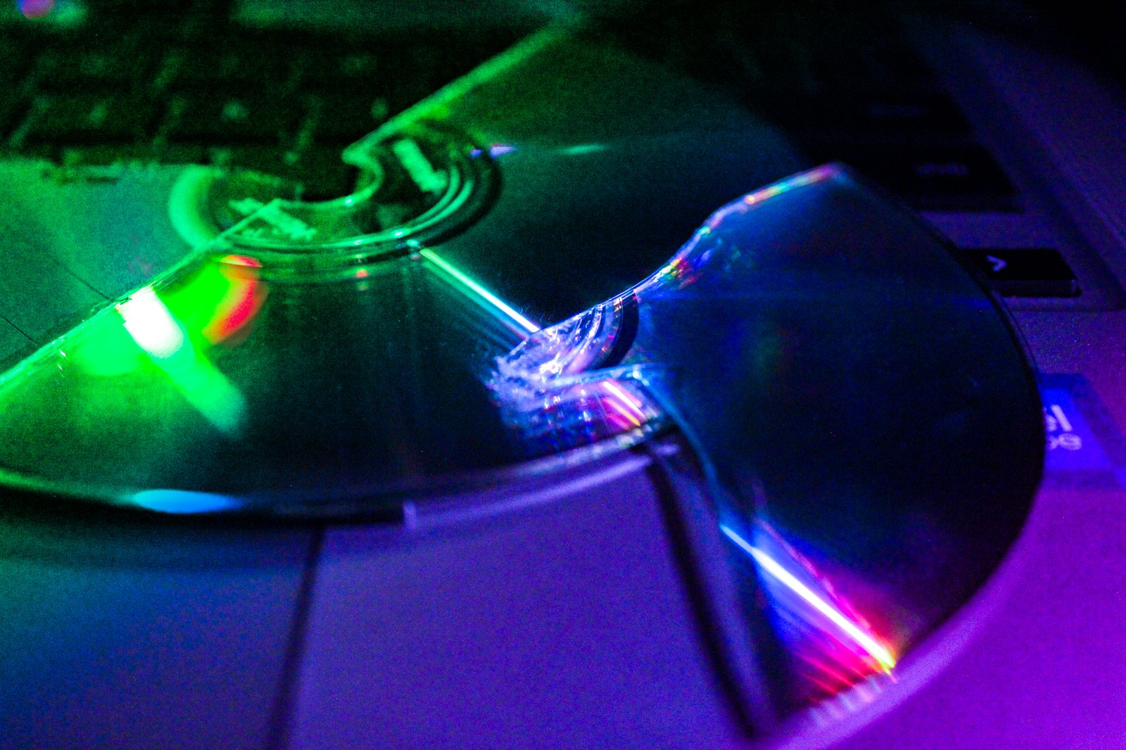 Green and magenta split across a cracked jewel case