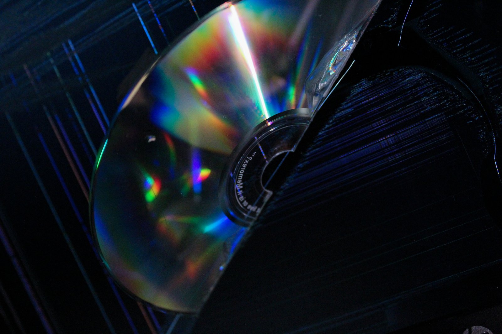 Stack of jewel cases with rainbow reflections
