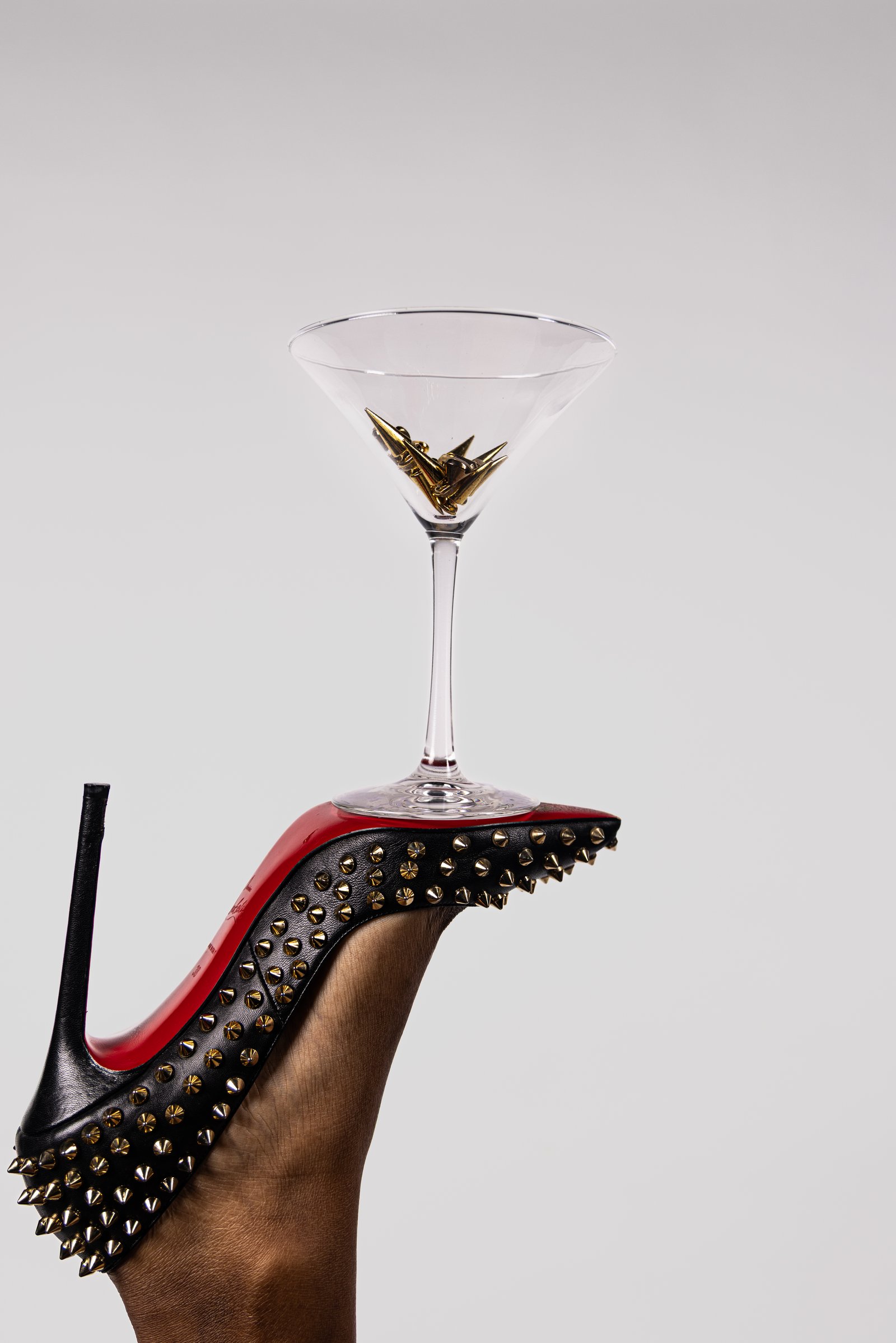 Tan stiletto with violet-topped martini